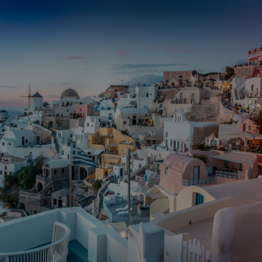White architecture and blue domes of Santorini at sunset — ideal for island weddings and celebrations.