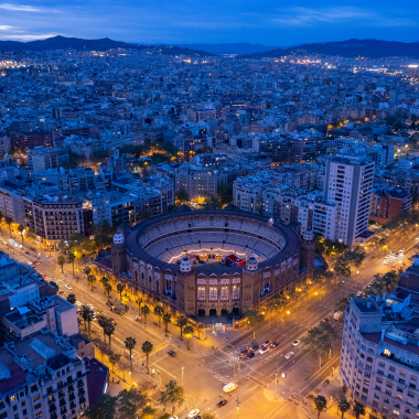 Aerial night view of La Monumental in Barcelona, Spain, representing urban Mediterranean flair for stylish events.