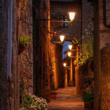 Charming illuminated stone alley in a Tuscany village, Italy, perfect for rustic countryside wedding destinations.